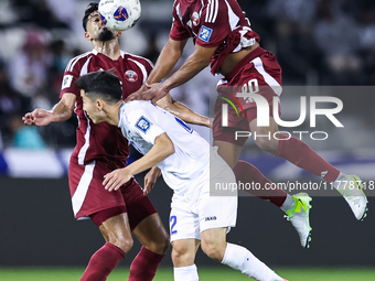 Ahmed Fathy (#20) of Qatar battles for the ball with Abbosbek Fayazullaev (#22) of Uzbekistan during the FIFA World Cup 2026 AFC Asian Quali...