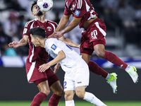 Ahmed Fathy (#20) of Qatar battles for the ball with Abbosbek Fayazullaev (#22) of Uzbekistan during the FIFA World Cup 2026 AFC Asian Quali...