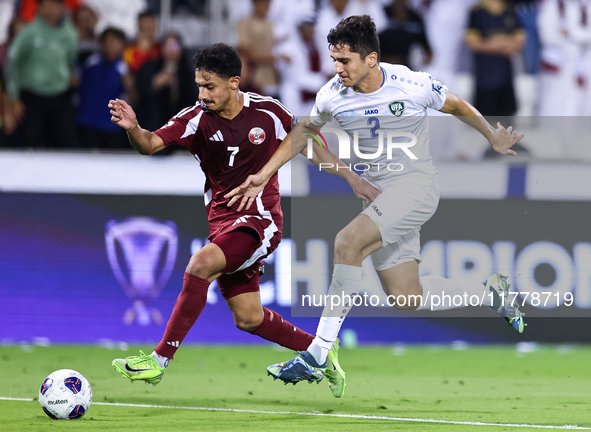 Ahmed Alggannehi (#7) of Qatar battles for the ball with Abdukodir Khusanov (#2) of Uzbekistan during the FIFA World Cup 2026 AFC Asian Qual...