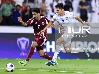 Ahmed Alggannehi (#7) of Qatar battles for the ball with Abdukodir Khusanov (#2) of Uzbekistan during the FIFA World Cup 2026 AFC Asian Qual...