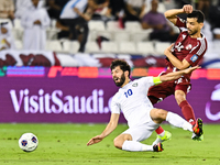 Boualem Khoukhi (#16) of Qatar battles for the ball with Jaloliddin Masharipov (#10) of Uzbekistan during the FIFA World Cup 2026 AFC Asian...