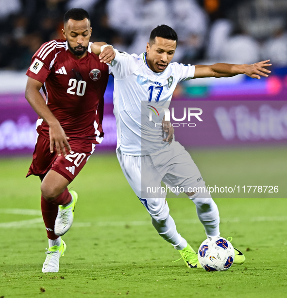 Ahmed Fathy (#20) of Qatar battles for the ball with Bobir Abdixolikov (#17) of Uzbekistan during the FIFA World Cup 2026 AFC Asian Qualifie...