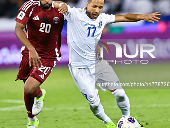 Ahmed Fathy (#20) of Qatar battles for the ball with Bobir Abdixolikov (#17) of Uzbekistan during the FIFA World Cup 2026 AFC Asian Qualifie...