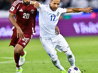 Ahmed Fathy (#20) of Qatar battles for the ball with Bobir Abdixolikov (#17) of Uzbekistan during the FIFA World Cup 2026 AFC Asian Qualifie...