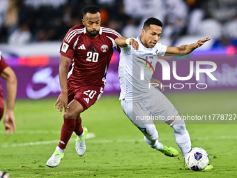 Ahmed Fathy (#20) of Qatar battles for the ball with Bobir Abdixolikov (#17) of Uzbekistan during the FIFA World Cup 2026 AFC Asian Qualifie...