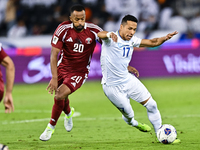 Ahmed Fathy (#20) of Qatar battles for the ball with Bobir Abdixolikov (#17) of Uzbekistan during the FIFA World Cup 2026 AFC Asian Qualifie...