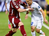 Bassam Alrawi (#15) of Qatar battles for the ball with Abbosbek Fayazullaev (#22) of Uzbekistan during the FIFA World Cup 2026 AFC Asian Qua...