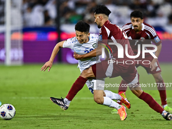 Tarek Salmann of Qatar battles for the ball with Abbosbek Fayazullaev of Uzbekistan during the FIFA World Cup 2026 AFC Asian Qualifiers thir...