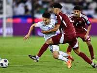 Tarek Salmann of Qatar battles for the ball with Abbosbek Fayazullaev of Uzbekistan during the FIFA World Cup 2026 AFC Asian Qualifiers thir...