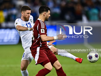 Bassam Alrawi of Qatar battles for the ball with Sherzod Asullaev of Uzbekistan during the FIFA World Cup 2026 AFC Asian Qualifiers third ro...