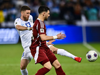 Bassam Alrawi of Qatar battles for the ball with Sherzod Asullaev of Uzbekistan during the FIFA World Cup 2026 AFC Asian Qualifiers third ro...