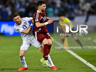 Bassam Alrawi of Qatar battles for the ball with Sherzod Asullaev of Uzbekistan during the FIFA World Cup 2026 AFC Asian Qualifiers third ro...