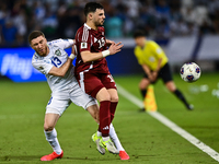 Bassam Alrawi of Qatar battles for the ball with Sherzod Asullaev of Uzbekistan during the FIFA World Cup 2026 AFC Asian Qualifiers third ro...