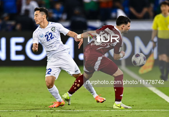 Bassam Alrawi of Qatar battles for the ball with Abbosbek Fayazullaev of Uzbekistan during the FIFA World Cup 2026 AFC Asian Qualifiers thir...