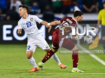 Bassam Alrawi of Qatar battles for the ball with Abbosbek Fayazullaev of Uzbekistan during the FIFA World Cup 2026 AFC Asian Qualifiers thir...