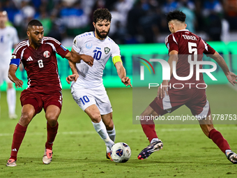 Tarek Salmann of Qatar battles for the ball with Jaloliddin Masharipov of Uzbekistan during the FIFA World Cup 2026 AFC Asian Qualifiers thi...