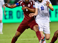 Tarek Salmann of Qatar battles for the ball with Jaloliddin Masharipov of Uzbekistan during the FIFA World Cup 2026 AFC Asian Qualifiers thi...