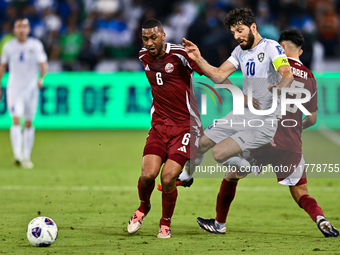 Tarek Salmann of Qatar battles for the ball with Jaloliddin Masharipov of Uzbekistan during the FIFA World Cup 2026 AFC Asian Qualifiers thi...