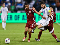 Tarek Salmann of Qatar battles for the ball with Jaloliddin Masharipov of Uzbekistan during the FIFA World Cup 2026 AFC Asian Qualifiers thi...