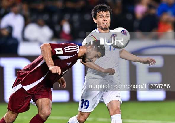 Mohammed Waad of Qatar battles for the ball with Azizbek Turgunboev of Uzbekistan during the FIFA World Cup 2026 AFC Asian Qualifiers third...