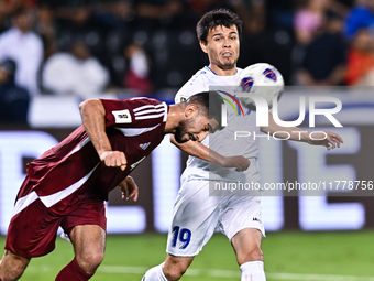 Mohammed Waad of Qatar battles for the ball with Azizbek Turgunboev of Uzbekistan during the FIFA World Cup 2026 AFC Asian Qualifiers third...