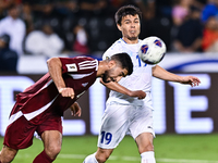 Mohammed Waad of Qatar battles for the ball with Azizbek Turgunboev of Uzbekistan during the FIFA World Cup 2026 AFC Asian Qualifiers third...