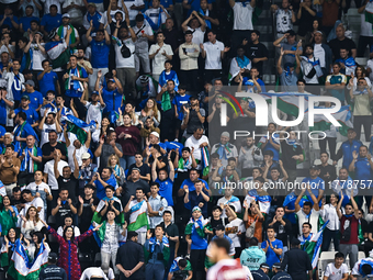 Fans from Uzbekistan cheer during the FIFA World Cup 2026 AFC Asian Qualifiers third round group A match between Qatar and Uzbekistan at Jas...