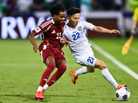 Yusuf Abdurisag (#11) of Qatar battles for the ball with Abbosbek Fayazullaev (#22) of Uzbekistan during the FIFA World Cup 2026 AFC Asian Q...