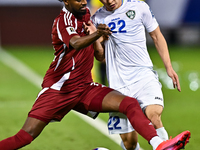 Yusuf Abdurisag (#11) of Qatar battles for the ball with Abbosbek Fayazullaev (#22) of Uzbekistan during the FIFA World Cup 2026 AFC Asian Q...