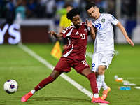 Yusuf Abdurisag (#11) of Qatar battles for the ball with Abbosbek Fayazullaev (#22) of Uzbekistan during the FIFA World Cup 2026 AFC Asian Q...