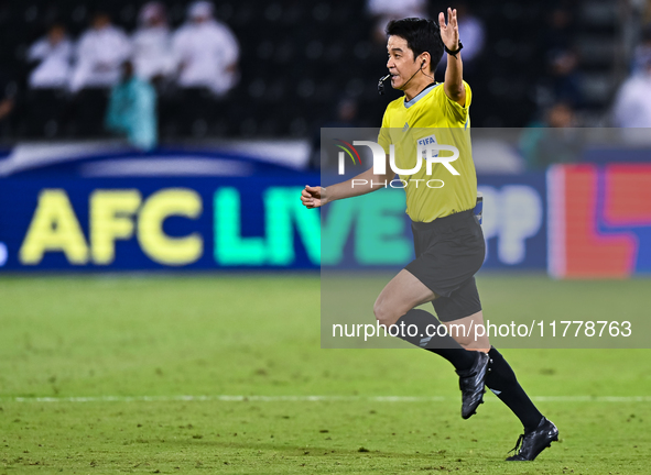 South Korean referee Kim Jong Hyeok gestures during the FIFA World Cup 2026 AFC Asian Qualifiers third round group A match between Qatar and...