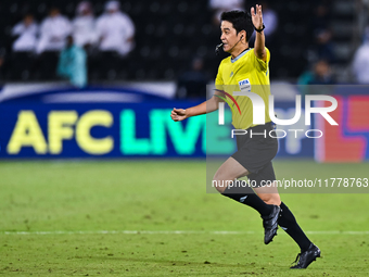 South Korean referee Kim Jong Hyeok gestures during the FIFA World Cup 2026 AFC Asian Qualifiers third round group A match between Qatar and...