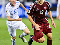 Lucas Mendes (#12) of Qatar battles for the ball with Farrukh Sayfiev (#4) of Uzbekistan during the FIFA World Cup 2026 AFC Asian Qualifiers...