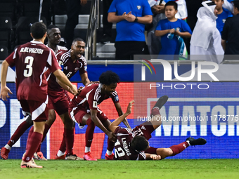 Lucas Mendes (bottom) of Qatar celebrates with his teammates after scoring the goal during the FIFA World Cup 2026 AFC Asian Qualifiers thir...