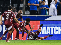 Lucas Mendes (bottom) of Qatar celebrates with his teammates after scoring the goal during the FIFA World Cup 2026 AFC Asian Qualifiers thir...