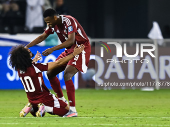 Akram Afif (C) (L) of Qatar and Mohammed Muntari (R) of Qatar celebrate after winning the FIFA World Cup 2026 AFC Asian Qualifiers third rou...