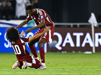 Akram Afif (C) (L) of Qatar and Mohammed Muntari (R) of Qatar celebrate after winning the FIFA World Cup 2026 AFC Asian Qualifiers third rou...