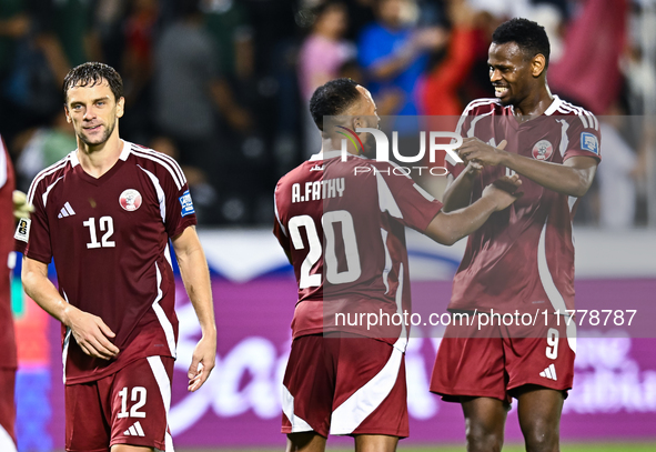 Lucas Mendes (L), Ahmed Fathy (C), and Mohammed Muntari (R) of Qatar celebrate after they win the FIFA World Cup 2026 AFC Asian Qualifiers t...