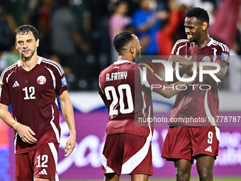 Lucas Mendes (L), Ahmed Fathy (C), and Mohammed Muntari (R) of Qatar celebrate after they win the FIFA World Cup 2026 AFC Asian Qualifiers t...