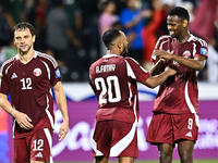 Lucas Mendes (L), Ahmed Fathy (C), and Mohammed Muntari (R) of Qatar celebrate after they win the FIFA World Cup 2026 AFC Asian Qualifiers t...