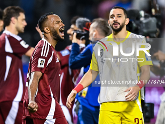 Ahmed Fathy (L) of Qatar celebrates after winning the FIFA World Cup 2026 AFC Asian Qualifiers third round group A match between Qatar and U...