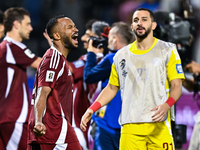 Ahmed Fathy (L) of Qatar celebrates after winning the FIFA World Cup 2026 AFC Asian Qualifiers third round group A match between Qatar and U...