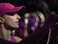 RIYADH, SAUDI ARABIA - NOVEMBER 07: Iga Swiatek of Poland with fans after winning her match against Daria Kasatkina, on Day 6 of the 2024 WT...