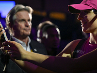 RIYADH, SAUDI ARABIA - NOVEMBER 07: Iga Swiatek of Poland with fans after winning her match against Daria Kasatkina, on Day 6 of the 2024 WT...