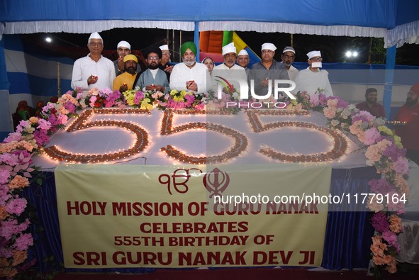 Devotees light diyas or eclectic lamps on the occasion of the 555th birth anniversary of Guru Nanak Dev in Kolkata, India, on November 15, 2...