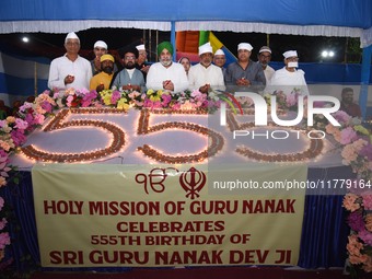 Devotees light diyas or eclectic lamps on the occasion of the 555th birth anniversary of Guru Nanak Dev in Kolkata, India, on November 15, 2...