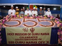 Devotees light diyas or eclectic lamps on the occasion of the 555th birth anniversary of Guru Nanak Dev in Kolkata, India, on November 15, 2...