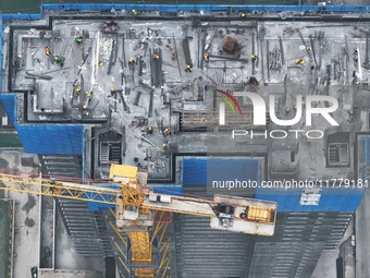 Workers work on the roof of a C&D Group property under construction in Nanjing, Jiangsu province, China, on November 15, 2024. On November 1...