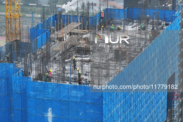 Workers work on the roof of a C&D Group property under construction in Nanjing, Jiangsu province, China, on November 15, 2024. On November 1...