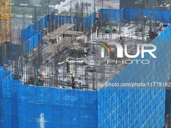 Workers work on the roof of a C&D Group property under construction in Nanjing, Jiangsu province, China, on November 15, 2024. On November 1...